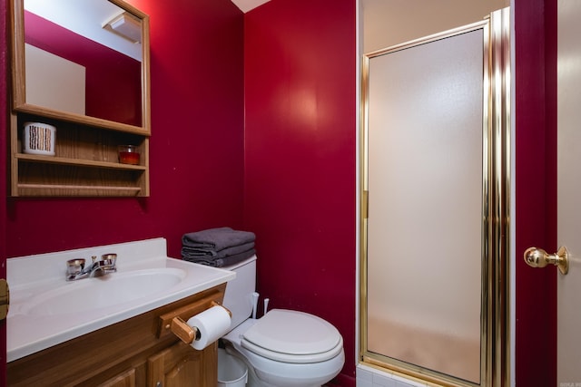 bathroom featuring a stall shower, vanity, and toilet