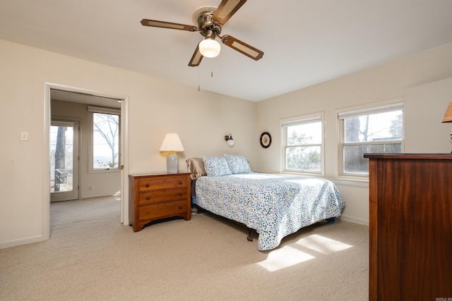 bedroom featuring light carpet, ceiling fan, and baseboards