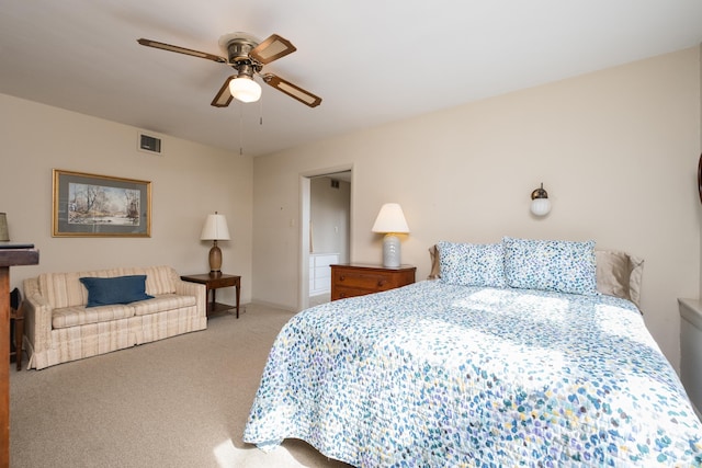 carpeted bedroom with baseboards, visible vents, and a ceiling fan