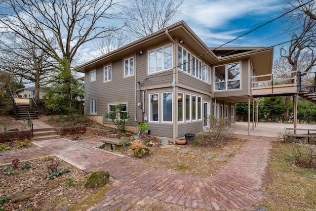 rear view of property with stairs