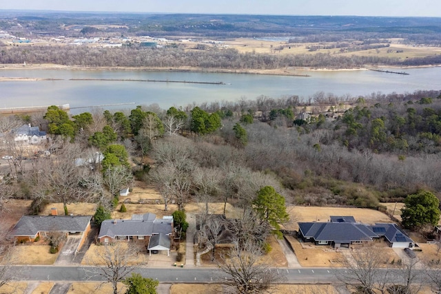 aerial view featuring a forest view and a water view