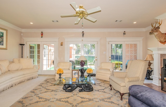 carpeted living room with visible vents, a fireplace, and crown molding