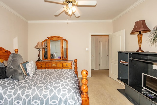 bedroom featuring crown molding, light colored carpet, and ceiling fan