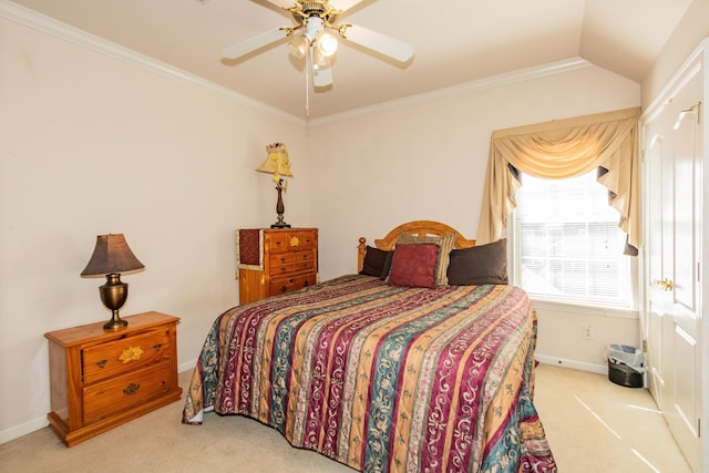 carpeted bedroom featuring ceiling fan, lofted ceiling, baseboards, and ornamental molding