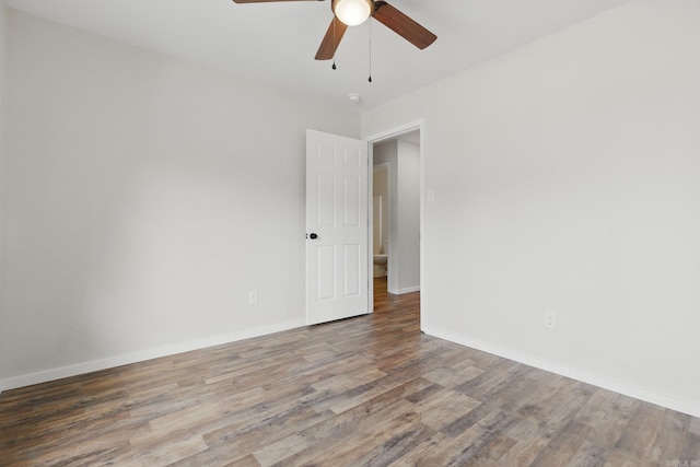 unfurnished room featuring ceiling fan, baseboards, and wood finished floors