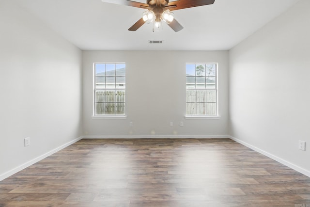 unfurnished room featuring visible vents, ceiling fan, baseboards, and wood finished floors