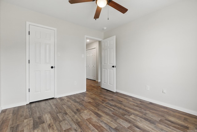 unfurnished bedroom with ceiling fan, baseboards, and wood finished floors