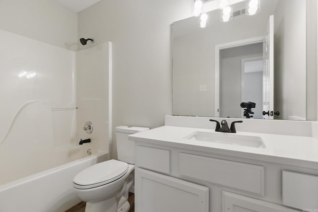 bathroom with shower / washtub combination, vanity, and toilet