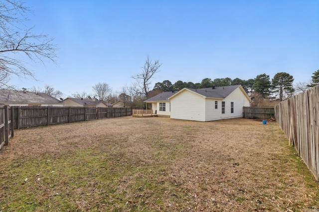 view of yard with a fenced backyard and a wooden deck