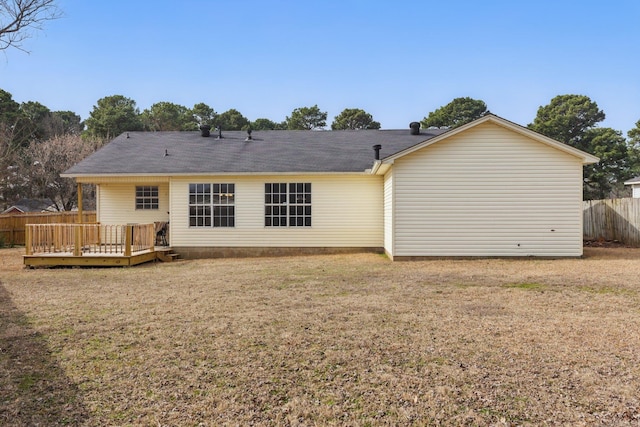 back of house with a yard, fence, and a wooden deck