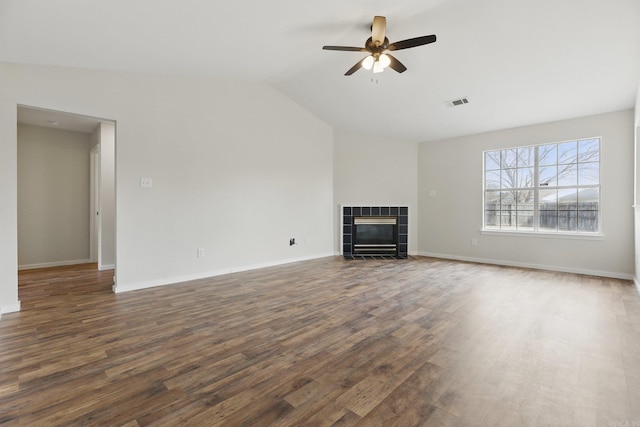 unfurnished living room with lofted ceiling, ceiling fan, a fireplace, wood finished floors, and baseboards