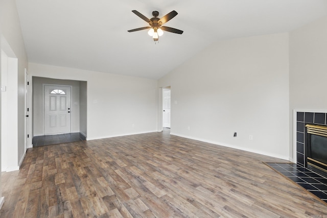 unfurnished living room with a ceiling fan, a fireplace, baseboards, and wood finished floors