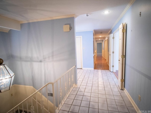 hallway featuring an upstairs landing, baseboards, ornamental molding, and tile patterned floors