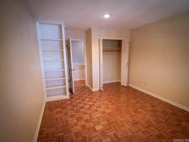 unfurnished bedroom with ornamental molding, a closet, and baseboards