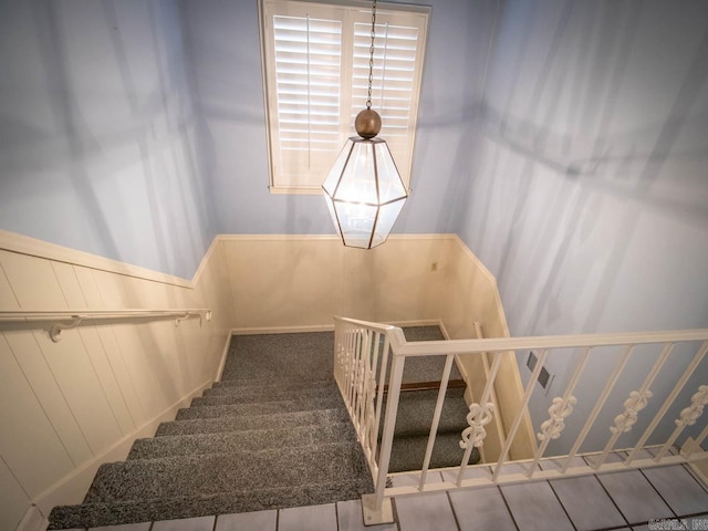 stairway featuring carpet floors