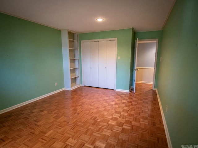 unfurnished bedroom featuring recessed lighting, baseboards, a closet, and ornamental molding