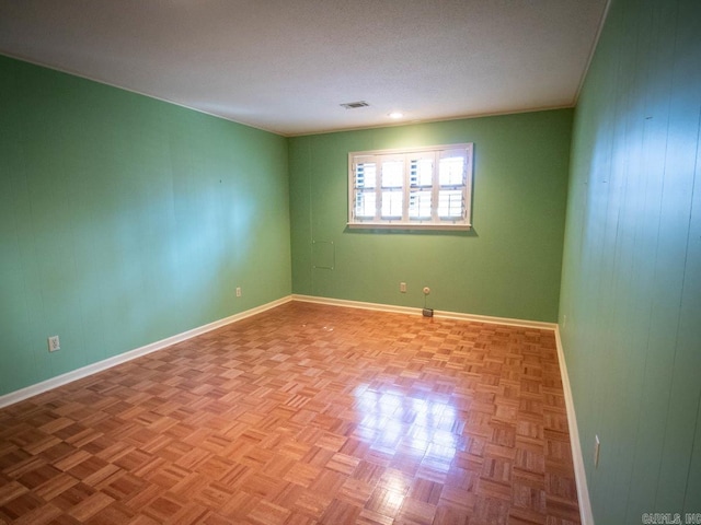 unfurnished room with visible vents and baseboards