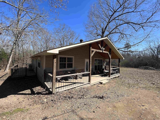 view of side of home featuring stone siding and a patio