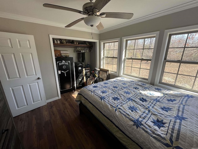 bedroom with multiple windows, dark wood-style flooring, a closet, and crown molding