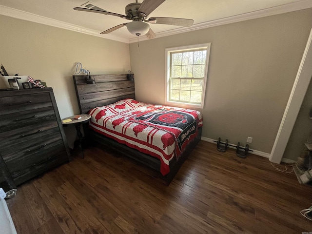 bedroom with baseboards, ceiling fan, wood finished floors, and crown molding