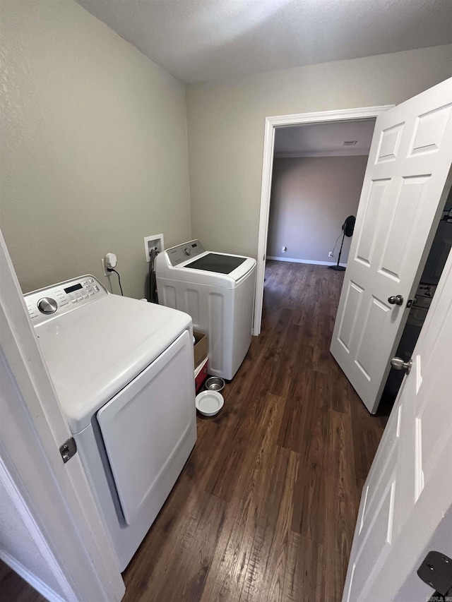 laundry room featuring laundry area, dark wood-style flooring, and washer and dryer