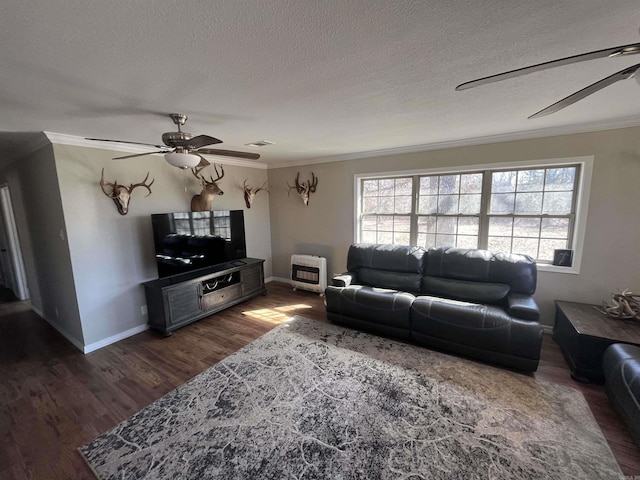 living room with visible vents, dark wood finished floors, heating unit, and ceiling fan