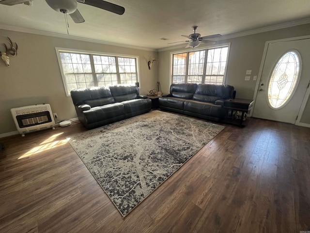 living area featuring heating unit, ceiling fan, crown molding, and wood finished floors