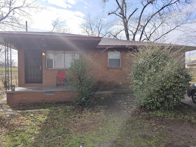 view of front facade featuring crawl space and brick siding