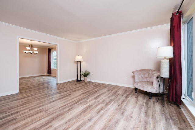 sitting room featuring crown molding, an inviting chandelier, wood finished floors, and baseboards