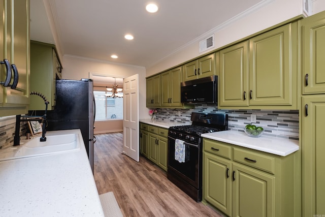 kitchen with black appliances, visible vents, light countertops, and green cabinetry