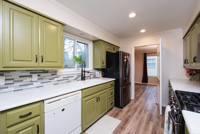 kitchen featuring black range with gas cooktop, white dishwasher, a sink, refrigerator with ice dispenser, and green cabinetry