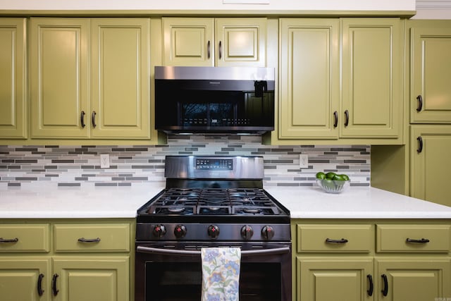 kitchen with green cabinets, light countertops, and gas range