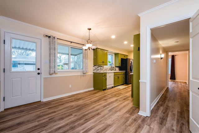 kitchen with green cabinetry, wood finished floors, stainless steel refrigerator with ice dispenser, dishwasher, and crown molding