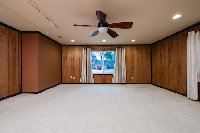 spare room featuring attic access, wooden walls, visible vents, light colored carpet, and recessed lighting