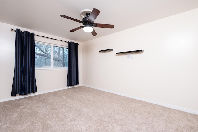 carpeted empty room featuring a ceiling fan