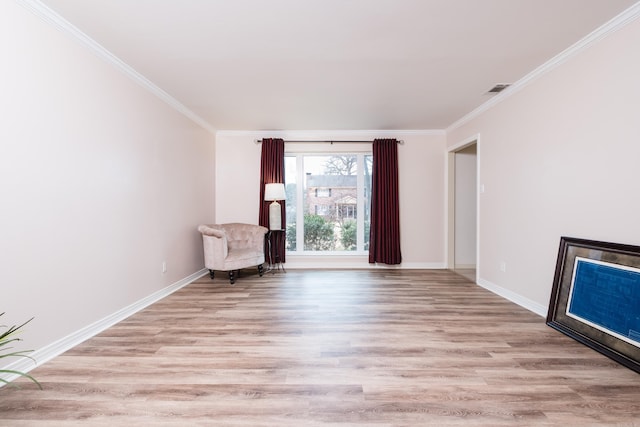 unfurnished room featuring light wood-type flooring, baseboards, and ornamental molding