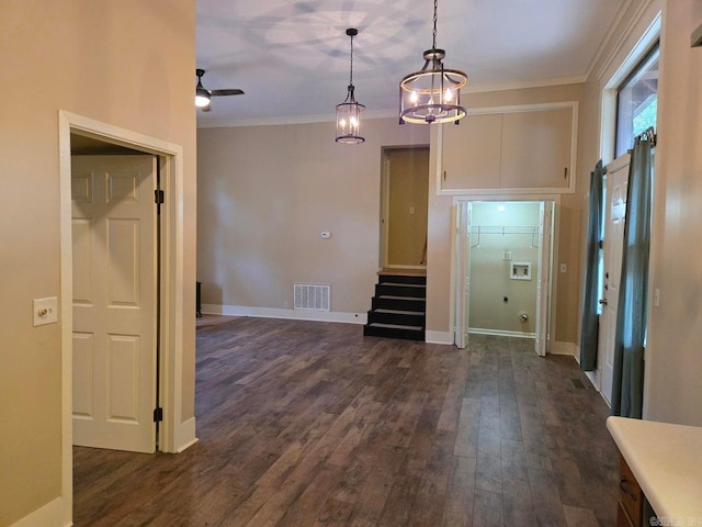 interior space featuring dark wood-style flooring, visible vents, and crown molding