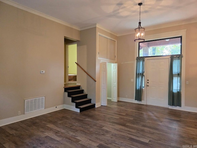 entrance foyer with dark wood-style flooring, visible vents, ornamental molding, baseboards, and stairs