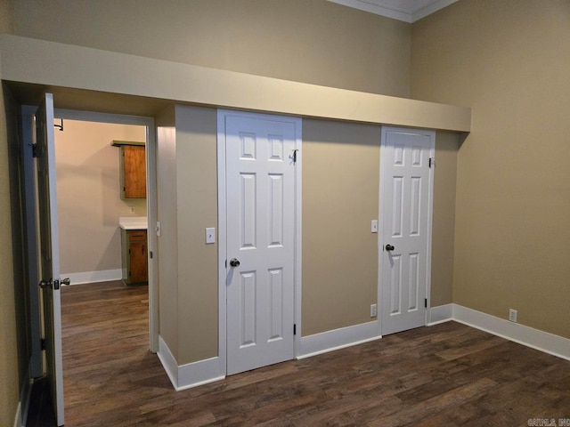 interior space featuring dark wood finished floors and baseboards