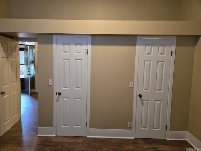 interior space with dark wood-style floors and baseboards