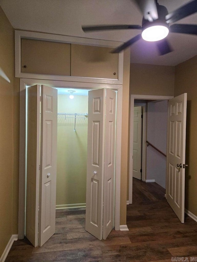 hall with baseboards and wood finished floors