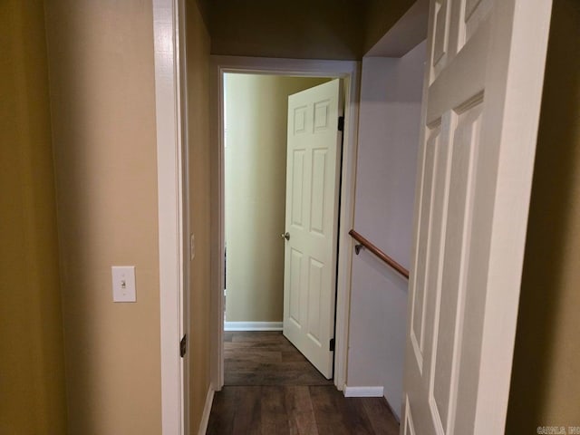 hall featuring baseboards and dark wood finished floors