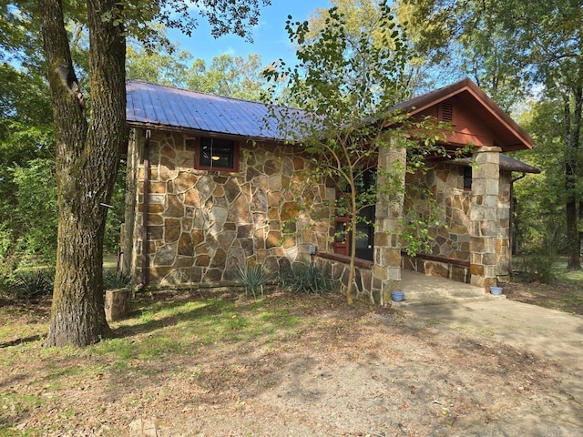 view of front of property with metal roof and stone siding