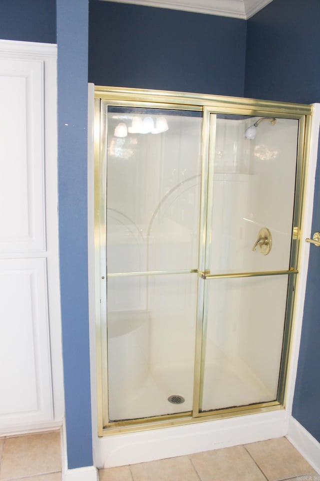 full bathroom featuring tile patterned flooring, a shower stall, and baseboards