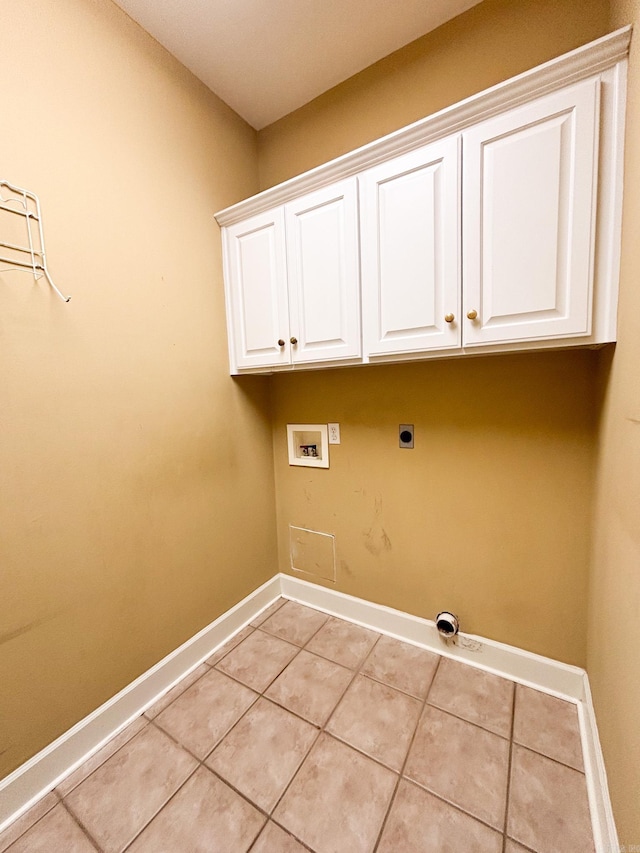 washroom with cabinet space, light tile patterned floors, baseboards, hookup for an electric dryer, and washer hookup