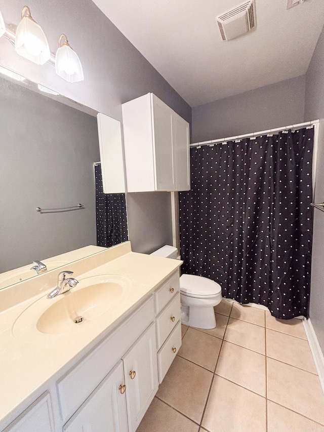 bathroom with tile patterned flooring, toilet, vanity, visible vents, and a shower with curtain