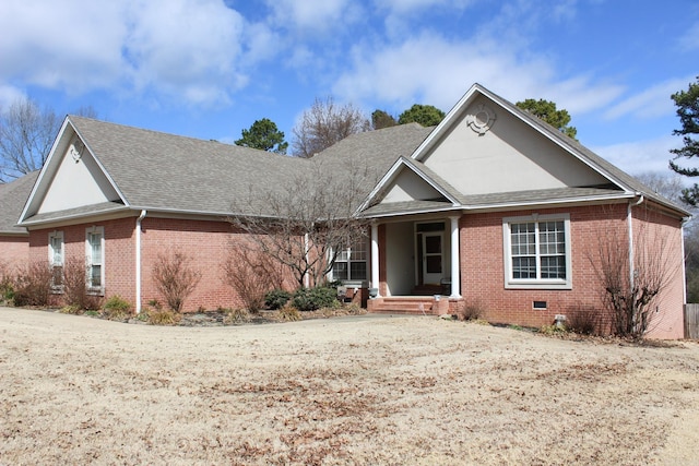 view of front of home featuring crawl space, a shingled roof, and brick siding