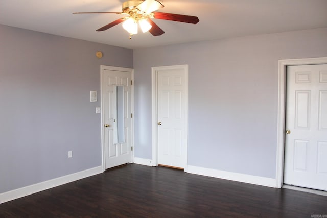 unfurnished room with ceiling fan, baseboards, and dark wood-style flooring