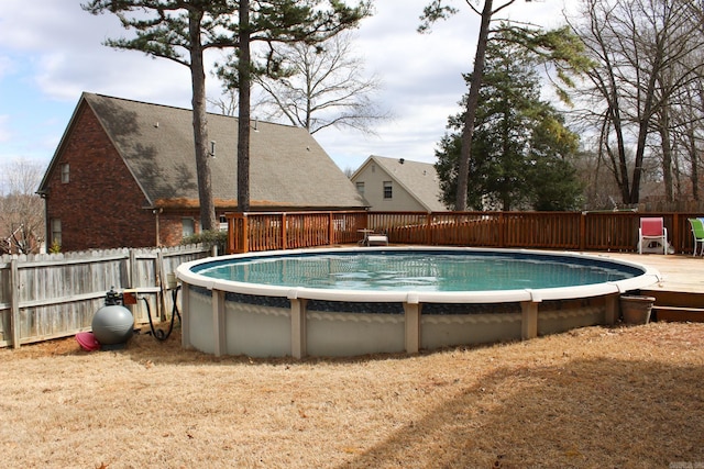 view of swimming pool featuring fence, a deck, and a fenced in pool