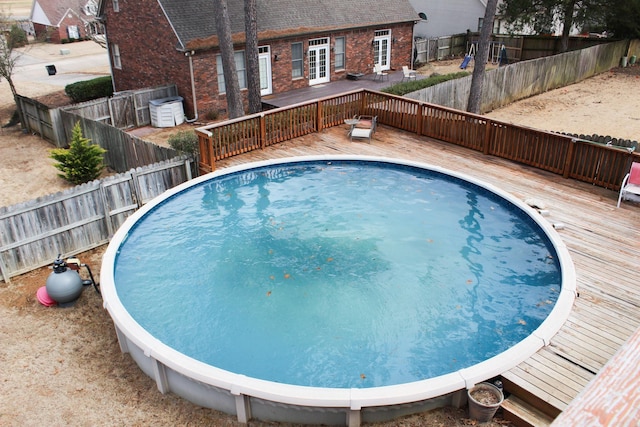 view of pool with a deck and a fenced backyard